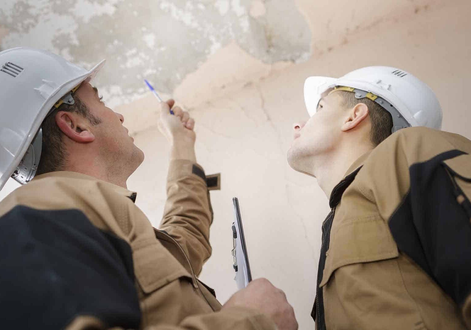 construction workers reviewing damage
