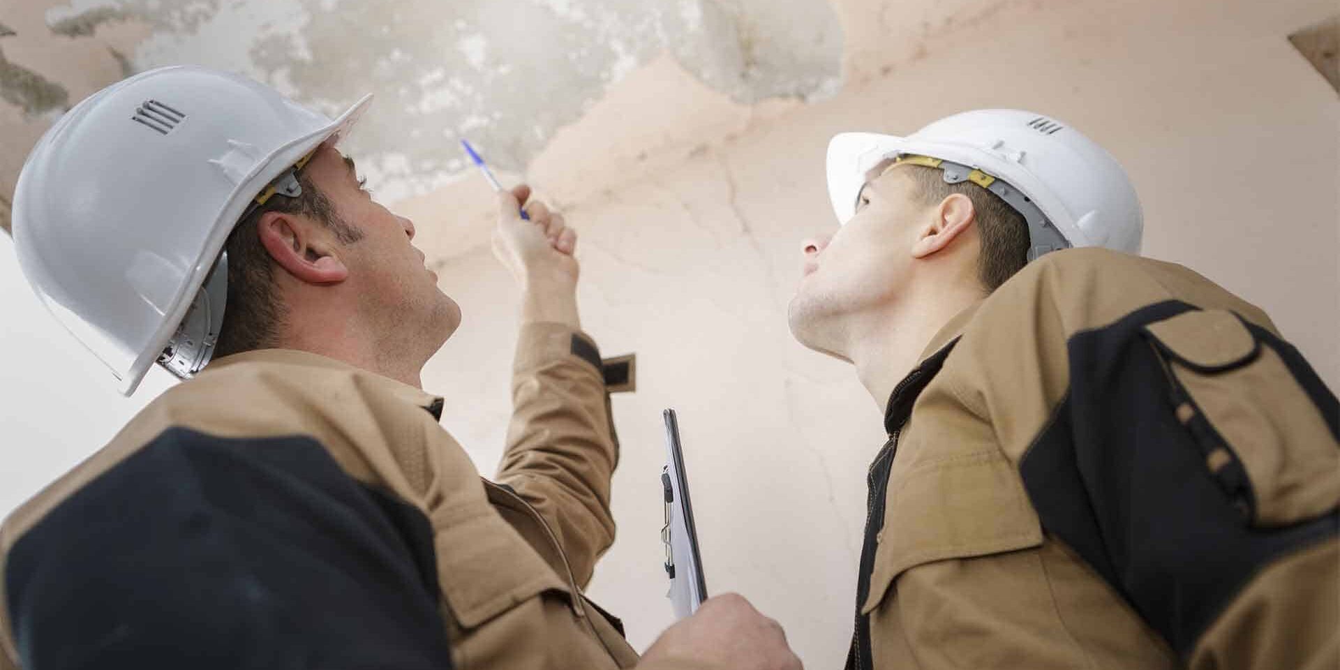 Reviewing-Damage construction workers reviewing damage